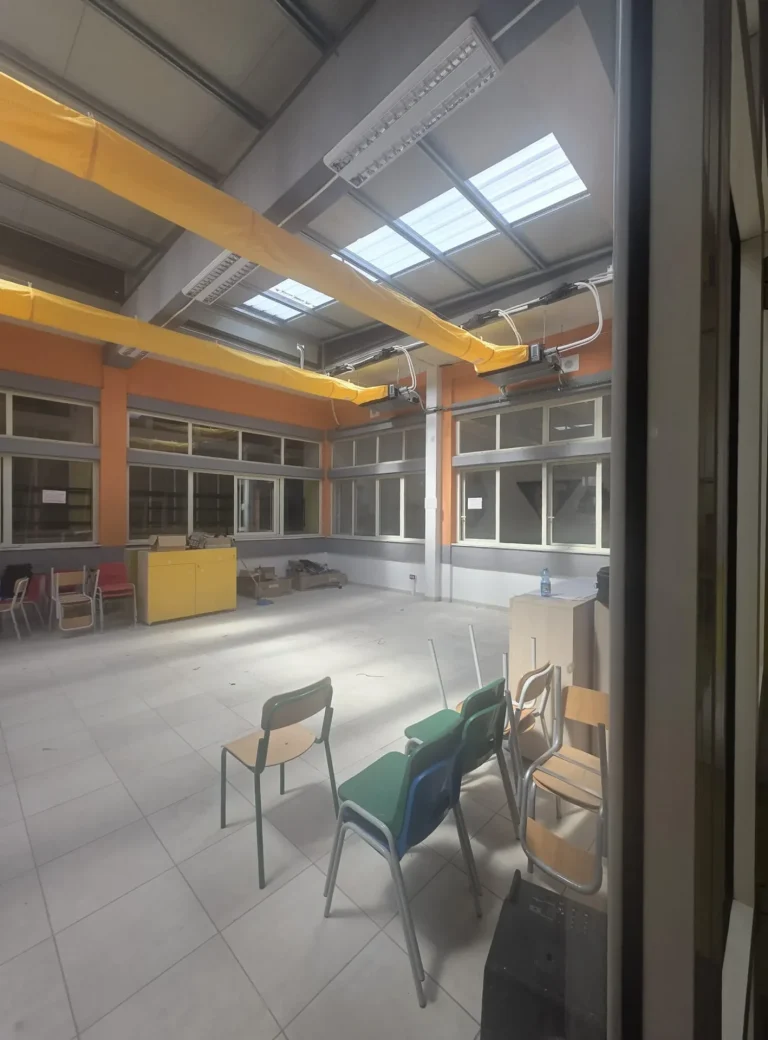 Canali tessili microforati sospesi nel salone con lucernari della scuola di Marina di Gioiosa Ionica